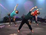 3 people standing with legs wide stretch to the side with one arm extended